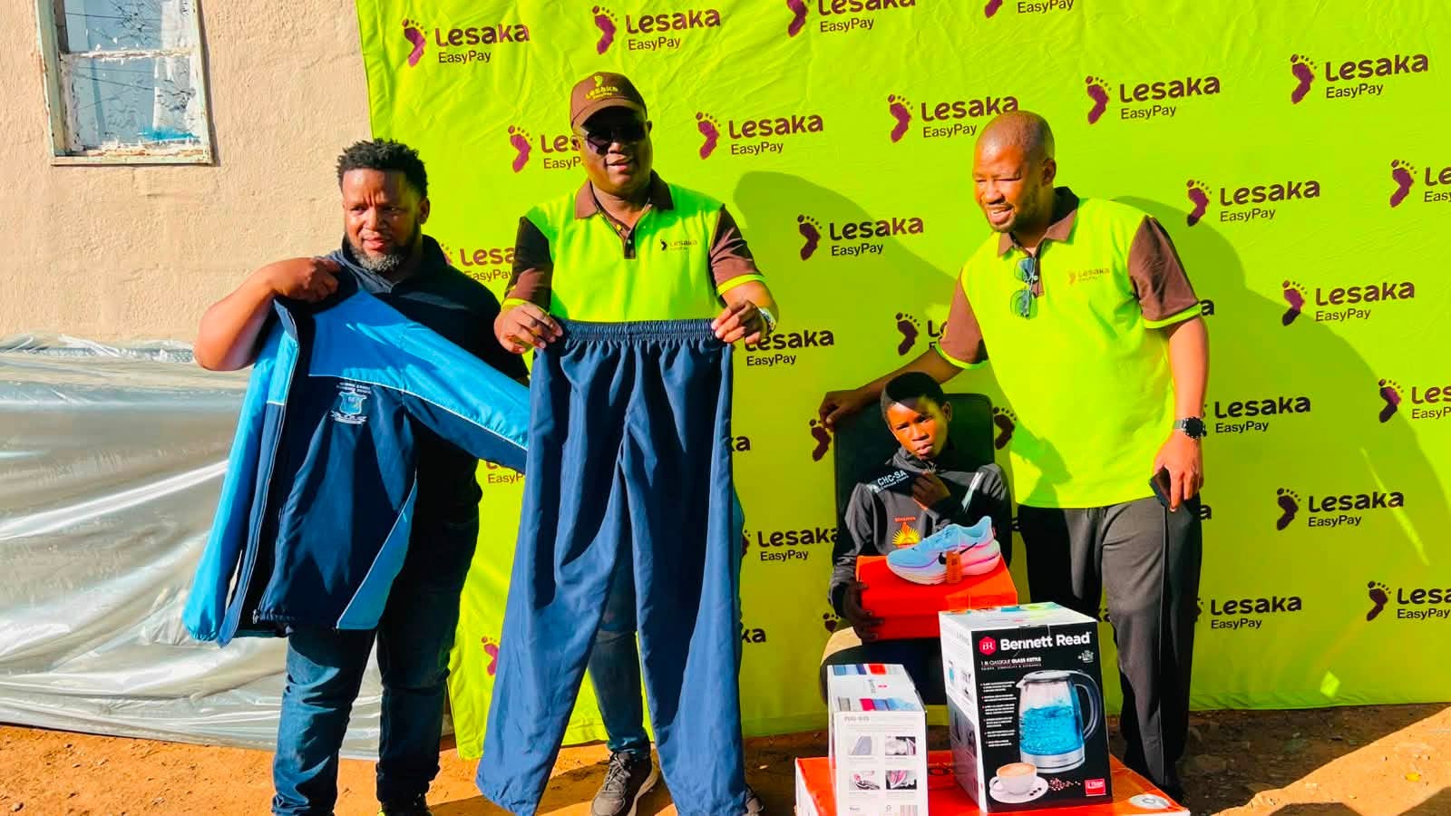 Avuyile receiving his new tracksuit, running shoes and household goods from the Mafa Bavuma Foundation and Lesaka EasyPay.